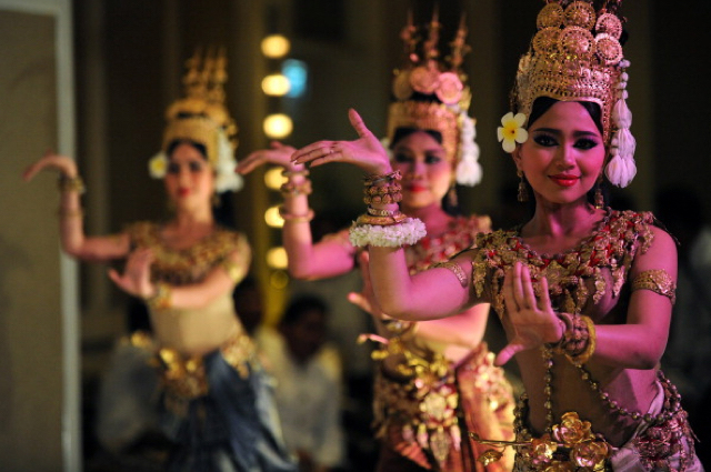 Adorned in glittering gold headdresses and accessories, with their...